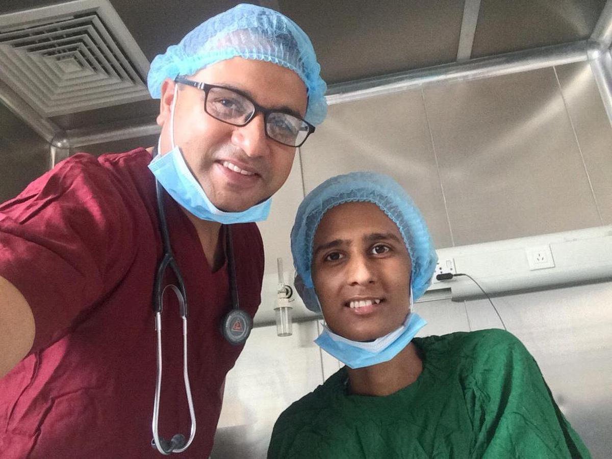 Dr. Bishesh Poudyal, left and his patient smile following the first successful bone marrow transplant at at Nepal’s new transplant center at Civil Service Hospital.