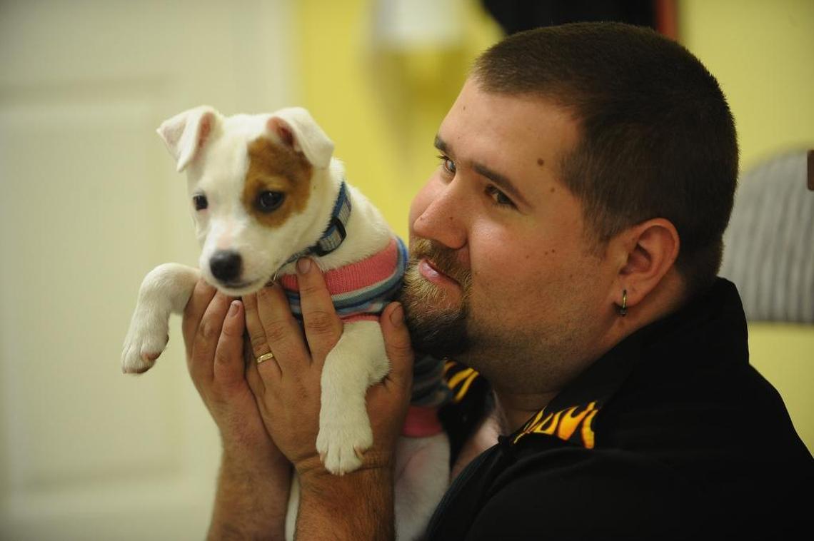 Iraq War veteran Daniel McKenzie of Bellingham plays with his new puppy Pip at Brigadoon Service Dogs on Mission Road east of Bellingham in 2012. Brigadoon Service Dogs provide service dogs to promote a more independent and enriched life for veterans, children and adults who need assistance.