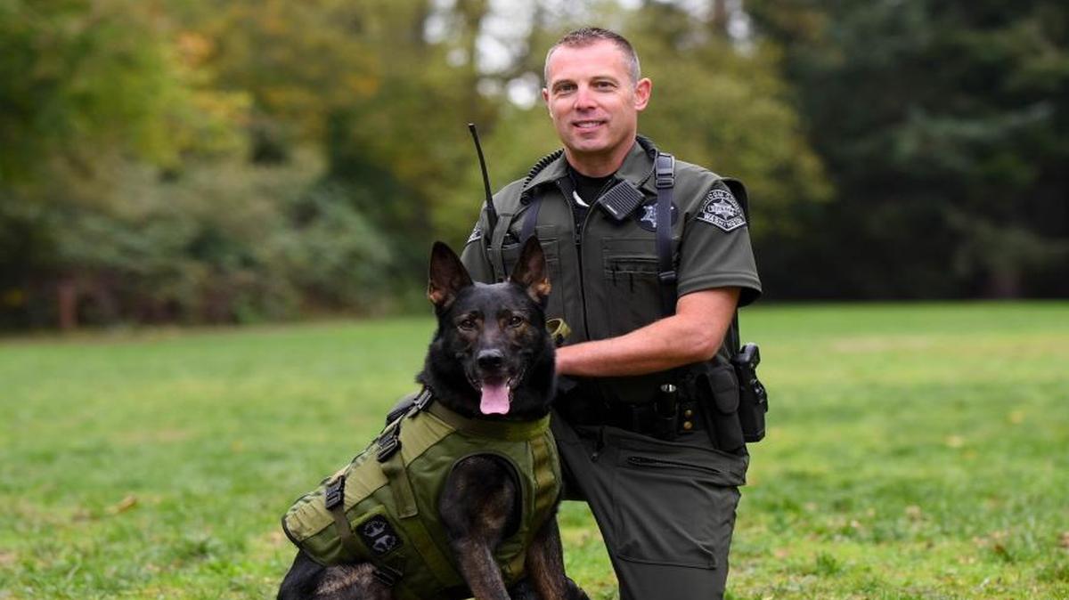 Whatcom County Sheriff’s Deputy Jason Nyhus, who is active Keeping K-9s in Kevlar, poses with police dog Hyde. The dog’s protective vest has a patch honoring Matt Herzog, a Whatcom County deputy killed in a car chase in September 2001.