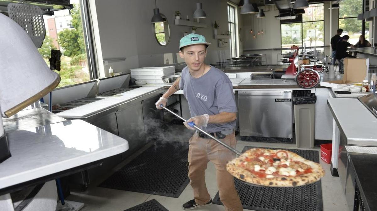 Line cook Doug Jambor takes out a pizza at Ovn Wood Fire Pizza, which opened in August 2015 at 1148 10th St., near the South Bay Trail in Fairhaven.