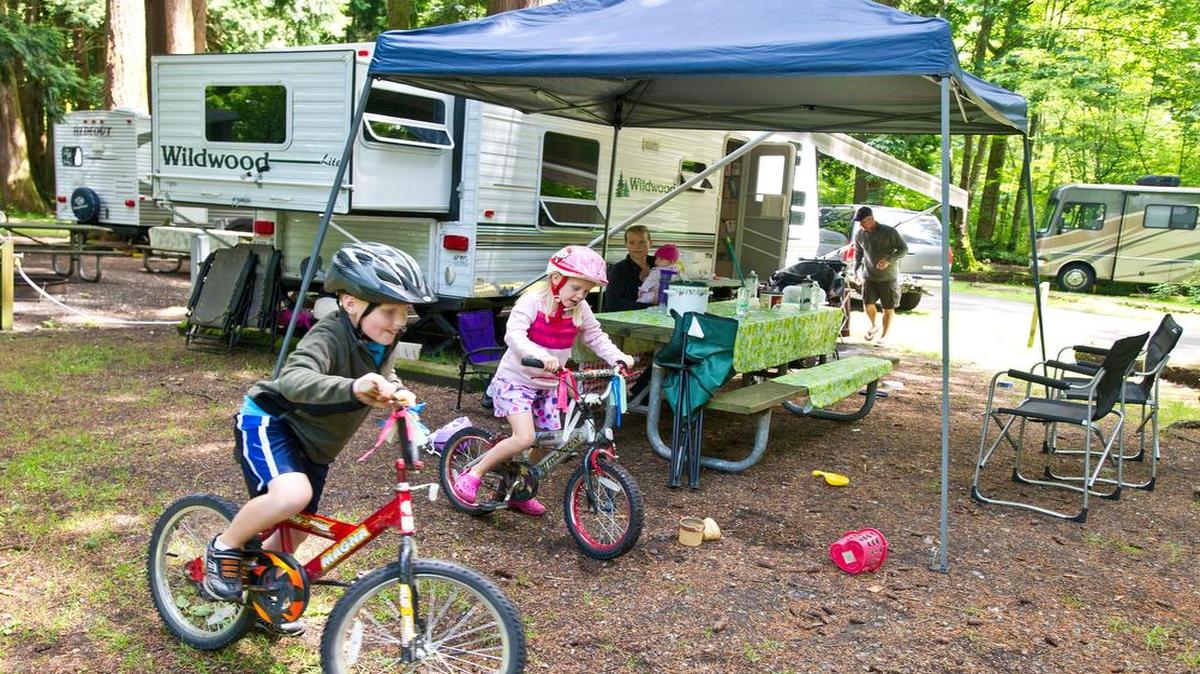 
Malachi and Reta VanderMey ride bikes at their campsite at Birch Bay State Park in June 2013. 
