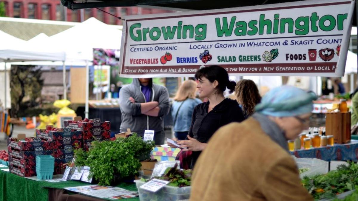Cecelia Hanford staffs the Growing Washington stall at Bellingham Farmers Market in May 2015.