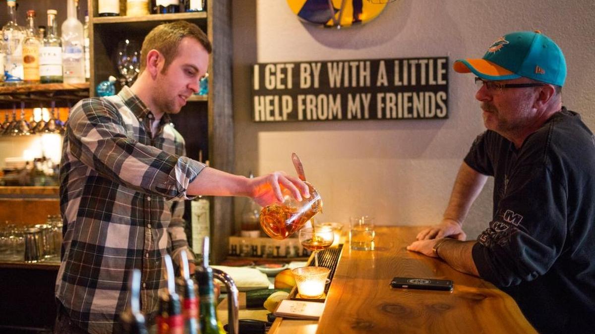 Brandon Wicklund, the owner and bartender at The Real McCoy Home Bar & Kitchen, pours a drink for Greg Corp of Vancouver, B.C., in April 2016. Corp, who was passing through Bellingham on his way to Las Vegas, said he read about the cocktails of The Real McCoy on Yelp, and said he would return to the bar sometime.
