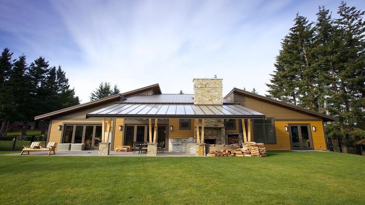 
The rear of a south Bellingham home built by Moceri Construction features a covered patio and an outdoor, wood-burning fireplace.
