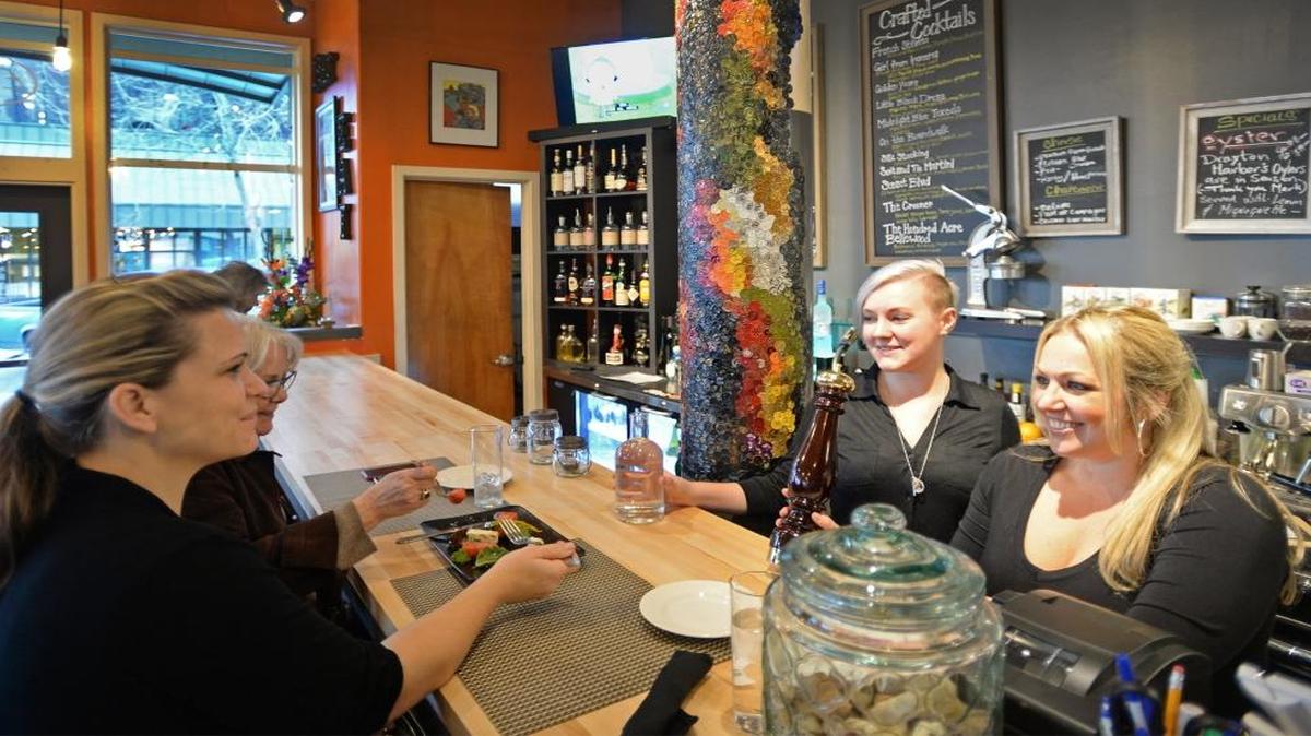 Customers Khara Turner, left, and Alana Hansen are served by Lydia Davis and Brie Mueller at Eat Restaurant and Bar in downtown Bellingham in February 2016.