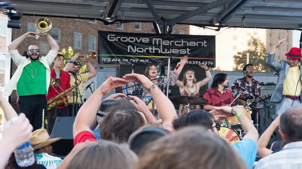 Concertgoers dance during a performance by Yogoman at Downtown Sounds in July 2015.