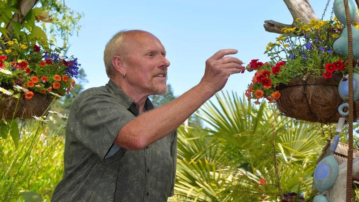 Shown in June 2015, John Hansen enjoys his garden at Neptune Beach.