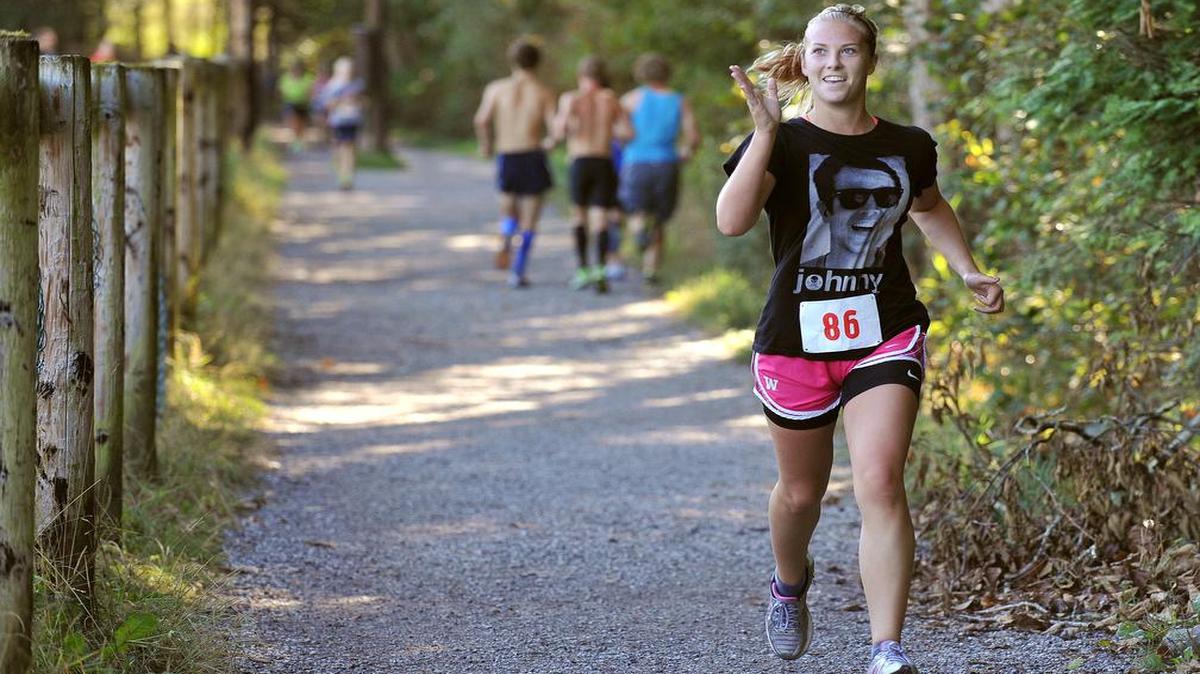 
Chloe Gardner waves to supporters during her leg of the race at the 2013 Lake Padden Relay.
