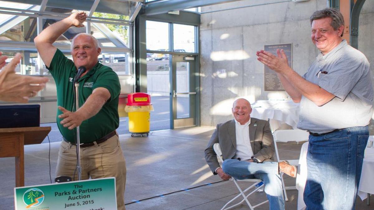 
Dick Henrie, left, recreation manager at Bellingham Parks and Recreation Department; Gary Jensen, center, Ferndale mayor; and Daniel Tepper, president of Whatcom Parks and Recreation Foundation, participate in a clapping game during the foundation’s “Parks and Partners Auction” fundraiser June 6, 2015, at Deport Market Square, Bellingham.
