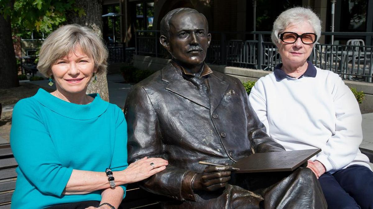 
Neelie Nelson, left, and Gayle Helgoe, seated at the J.J. Donovan statue, have created a website dedicated to the history of Fairhaven.

