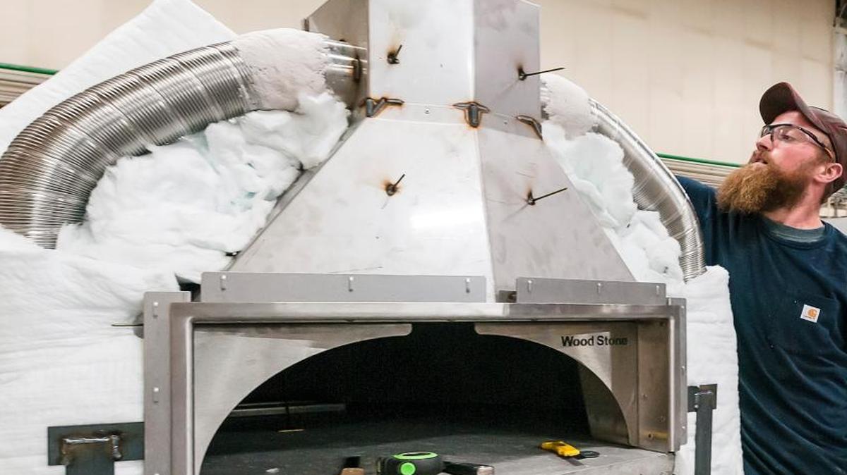 Michael Cozad installs high-density insulation around an oven being manufactured at Wood Stone Corp. in Bellingham in October 2015. Wood Stone makes wood and gas ovens used in restaurants and homes throughout the world.