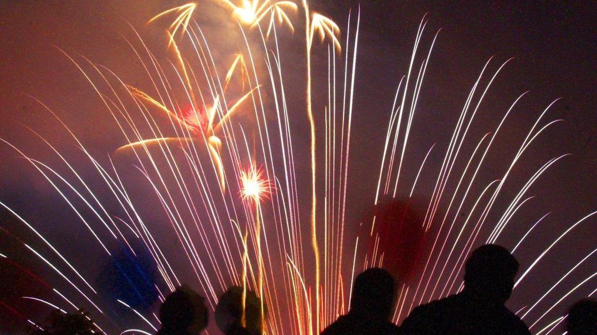 Spectators watch the fireworks in Bellingham from the top of a parking garage in downtown.