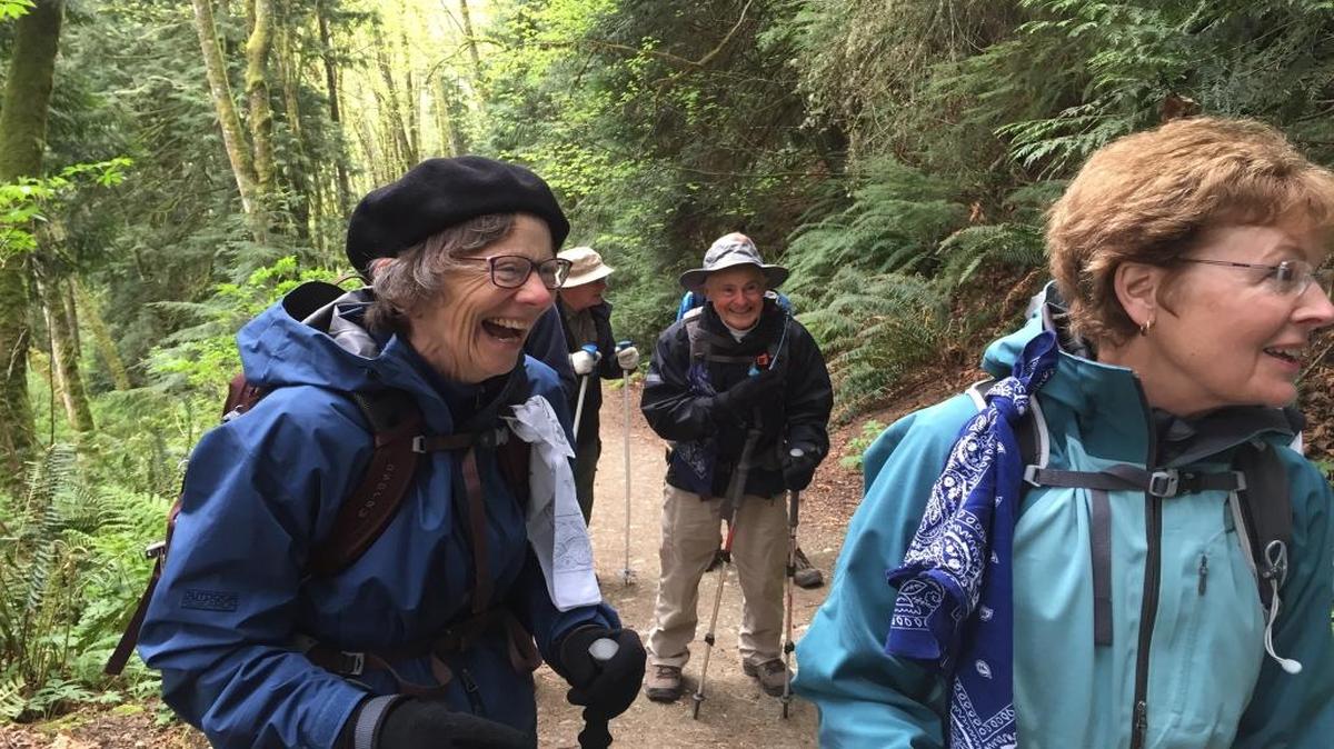 Jacqueline Anderson, left, Mike Welch, Ward Pletcher, and Peggy Vander Yacht, all members of Senior Trailblazers, enjoy a laugh during their April 2015 hike to Pine and Cedar lakes in the Chuckanuts.