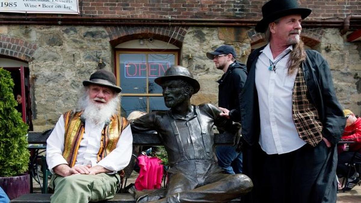 Jim Rich, left, and Richard Bulman, both from Fairhaven, hang out with the Dirty Dan statue at Fairhaven Village Green during the 2015 Dirty Dan Harris Festival. The 2016 event takes place April 24.