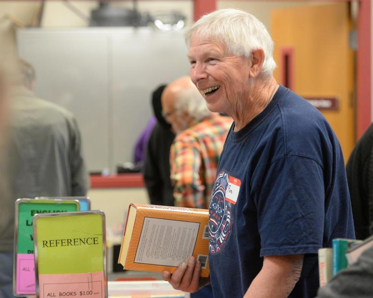 Volunteer Ron Peterson, 71, stacks books at the annual Ski to Sea Book Sale in May at the Bellingham Public Library. Peterson says he is an avid reader and listens to books on tape when he is driving.