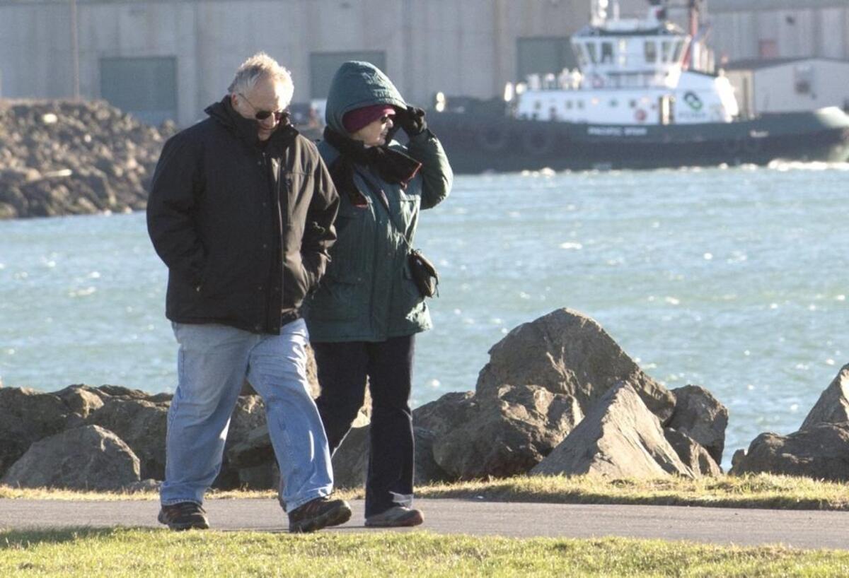 Bellingham residents Pete and Linda Chorney walk through Zuanich Park in December 2014.