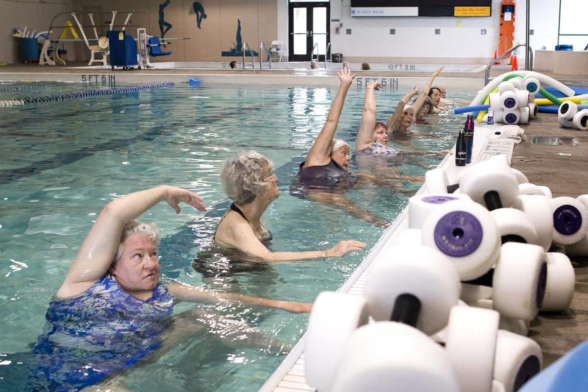 Participants in an arthritis exercise class follow the instructor’s directions at Arne Hanna Aquatic Center in Bellingham.
