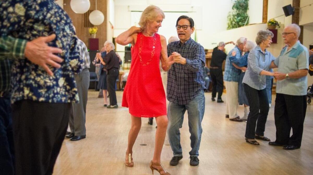 Donna Kuiken, left, and Danny Uy dance to the music of Good Vibrations at the Bellingham Senior Activity Center.