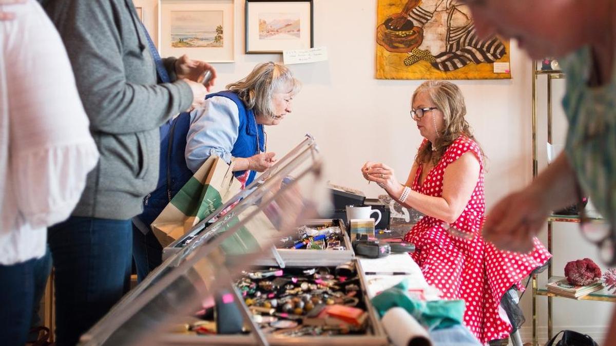 Franny Erickson, right, helps a customer at an estate sale put on by EarthaKittys in Bellingham.