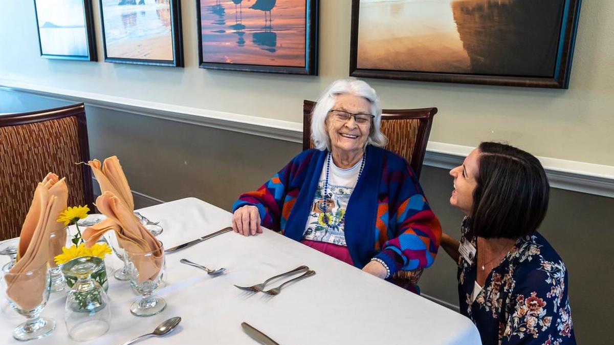 Resident Eleanor Flanders-Creek and senior administrator Laura Printy chat in one of the many dining rooms at Silverado – Bellingham.