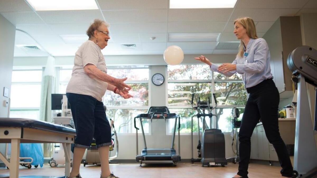 Sylvie De Rham Tortorelli, physical therapist, demonstrates fall prevention exercises with her former patient Jo Wagner on Friday, May 25, in Bellingham.
