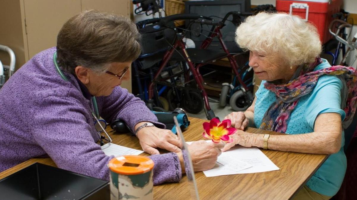 Faith community nurse Norma Maarhuis, left, counsels Lola Osgond about her blood-pressure reading Oct. 2, 2015, at Lynden Community Center.