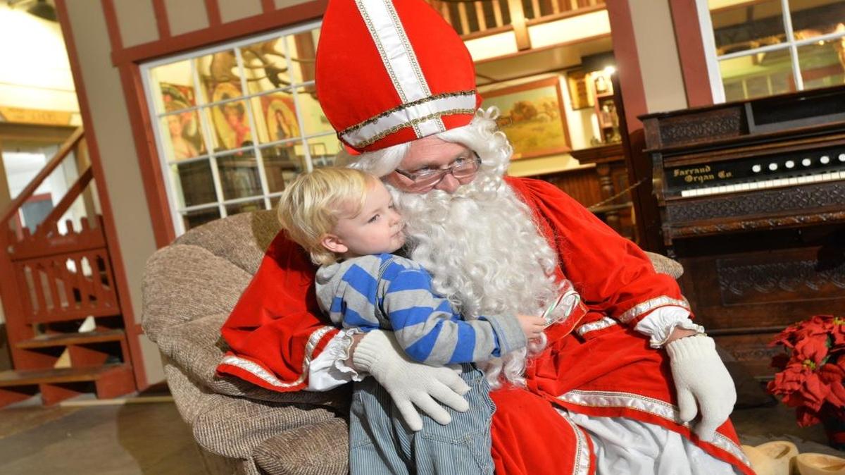 
Sinterklaas visits with River Scheepens, then 3, of Blaine, at Lynden Pioneer Museum in December 2013. Sinterklaas plans to visit Lynden Community Center during a benefit breakfast Dec. 5, 2015.
