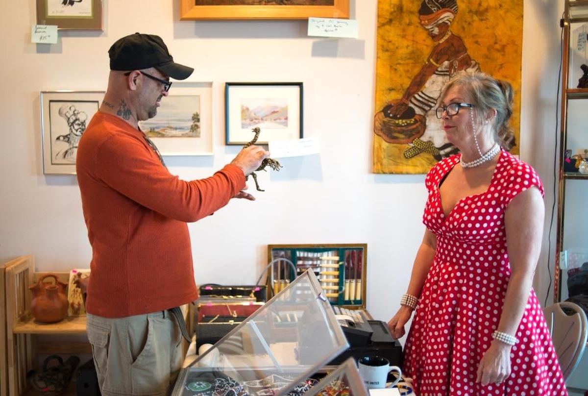 Franny Erickson, right, helps a customer at an estate sale put on by EarthaKittys in Bellingham.