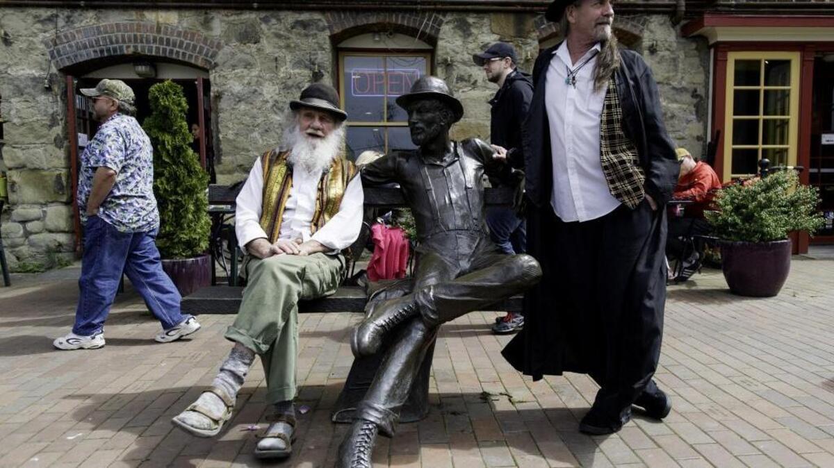 Jim “Dirty Dan” Rich, left, and Richard Bulman, both from Fairhaven, hang out at the Dirty Dan statue on Fairhaven Village Green during the annual Dirty Dan Harris Festival in April 2015.