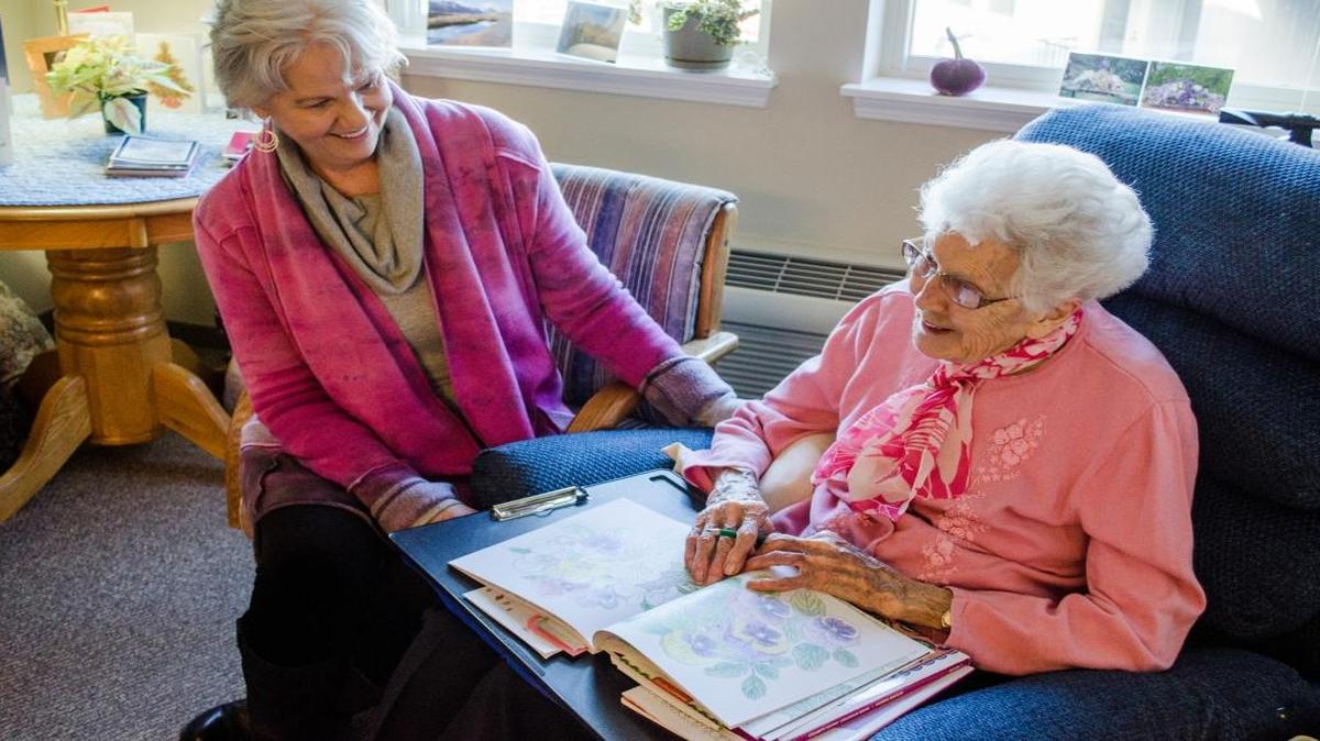 Caregiver Roberta Eubank watches as Elizabeth Freeberg, 98, draws with colored pencils Jan. 23, 2016, at Spring Creek in Bellingham.