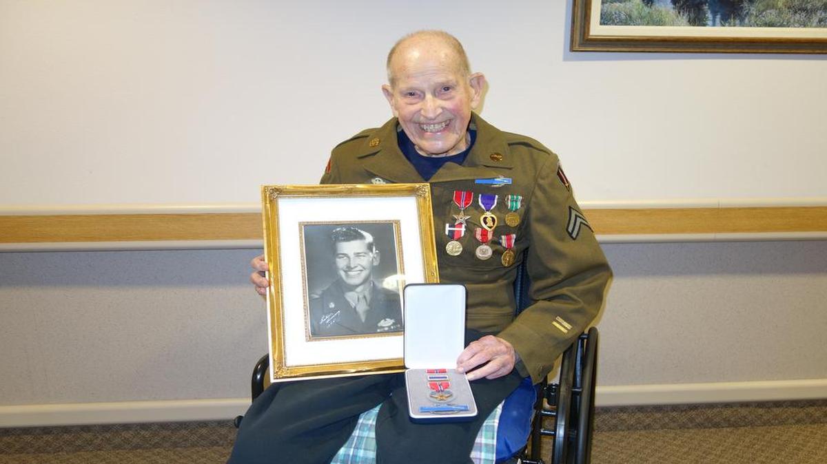 
Retired veterinarian Lauren Brown displays his service portrait and one of his overdue military medals from World War II that he received March 14, 2015, at Christian Health Care Center in Lynden. A longtime friend, David Kroontje, helped Brown compile evidence showing the medals should be awarded to him 70 years after the war’s end.
