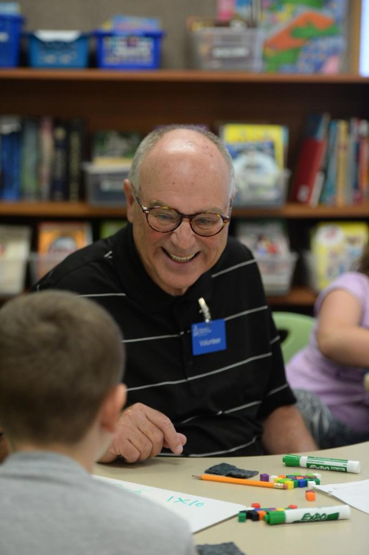 Volunteer Wayne Weinschenk, 71, tutors Josh Chiono, 9, in math at Cordata Elementary fourth grade class in Bellingham, Thursday, Sept. 14, 2017.