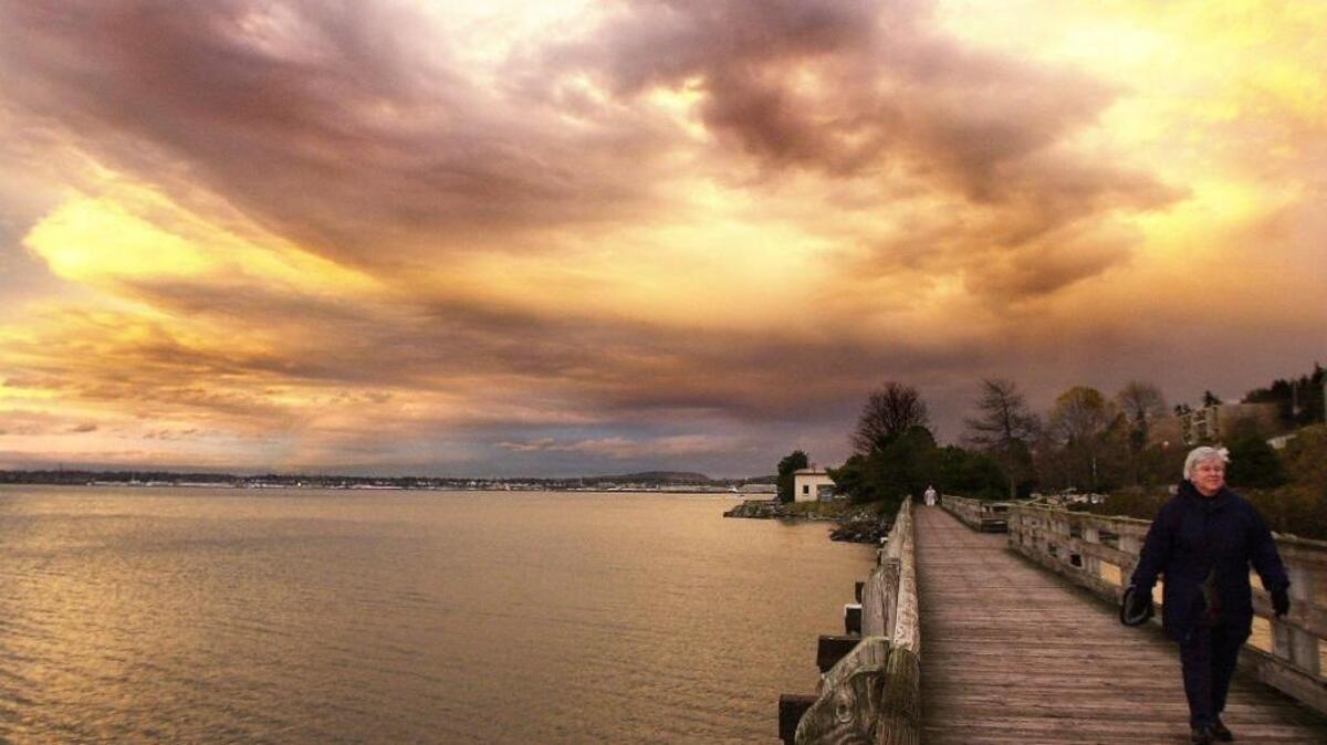 Rosemary Ryan walks the boardwalk at Boulevard Park as part of a regular walk to watch the sunset.