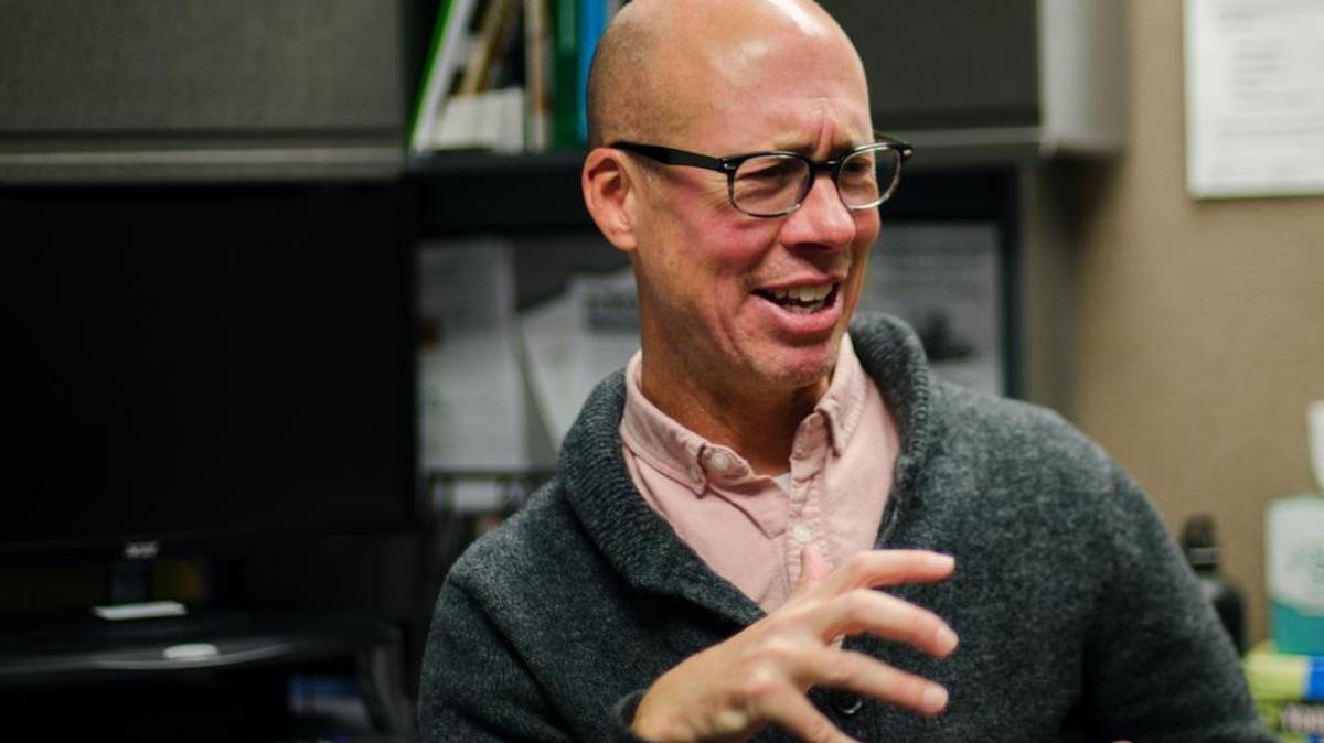 Joel Bergsbaken, program coordinator at the Bellingham Hearing, Speech and Deafness Center, speaks sign language to his colleague Dec. 2 in the center’s office downtown.