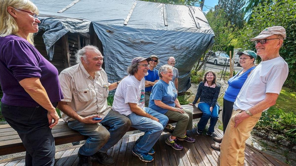 Former Western Washington University professor Bob Keller, right, chats during a break in an annual work party Sept. 3, 2016, at his and Pat Karlberg’s house in Bellingham. The group of former Western students, instructors, staff and family members has been meeting since 1999 to clean and repair their homes.