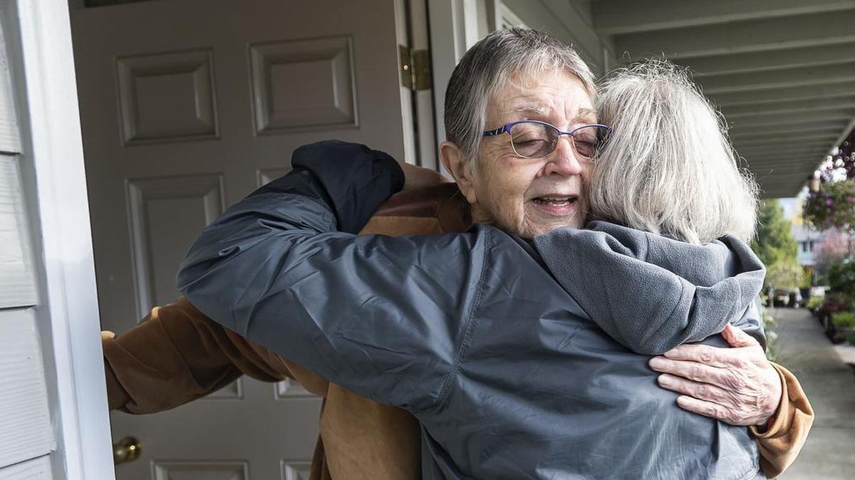 Ann Adam, 82, of Bellingham receives a departing hug from Meals on Wheels volunteer Marilyn Scheer after delivering her food order Oct. 18. Not only does the Meals on Wheels program provide food, it also gives those who are homebound an opportunity to socialize.