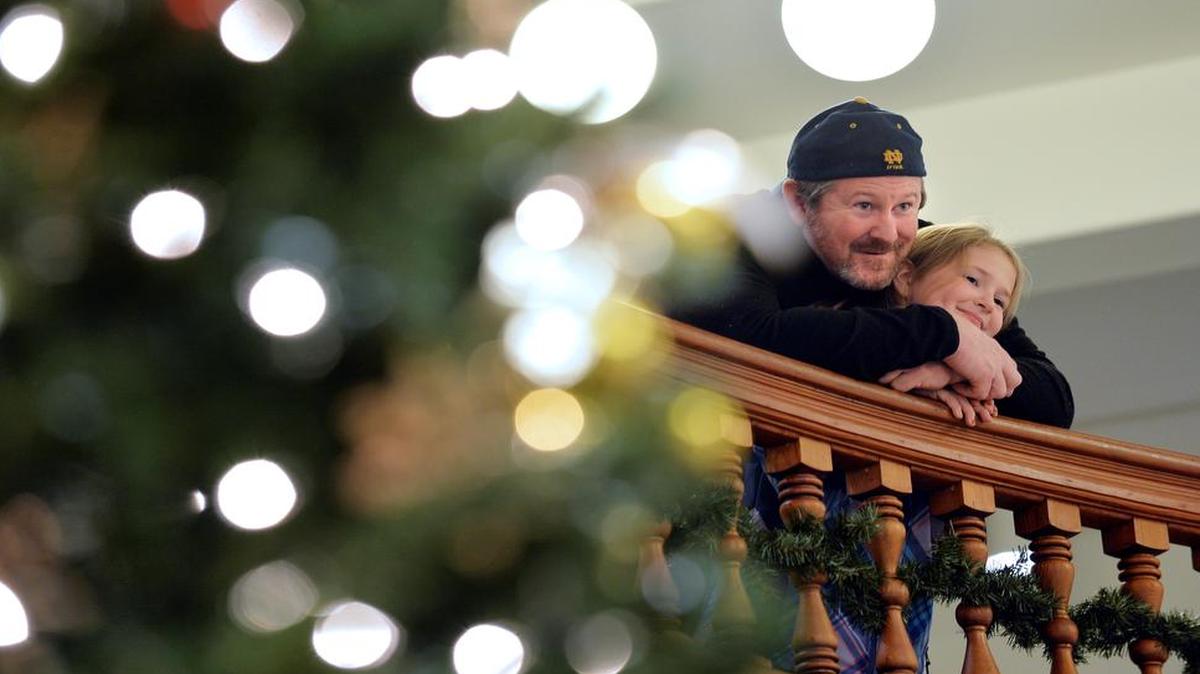 
 Joe Shearer and his daughter Tessa, then 8, look over decorated Christmas trees at Whatcom Museum’s Deck the (Old City) Hall lighting celebration in 2013. The 2015 event runs Nov. 27 through Jan. 3.
