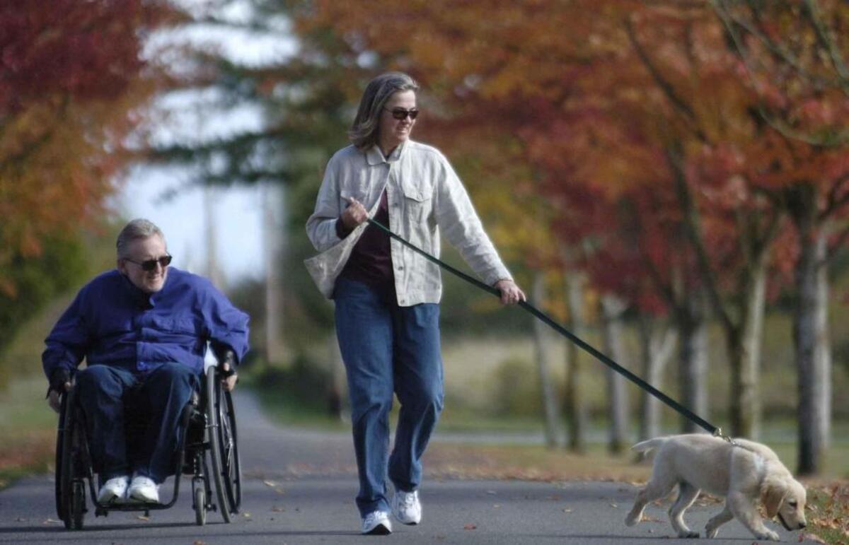 Bob and Kathy Rinneberg walk their 12-week old puppy Nila at Hovander Park in Ferndale in October 2005.