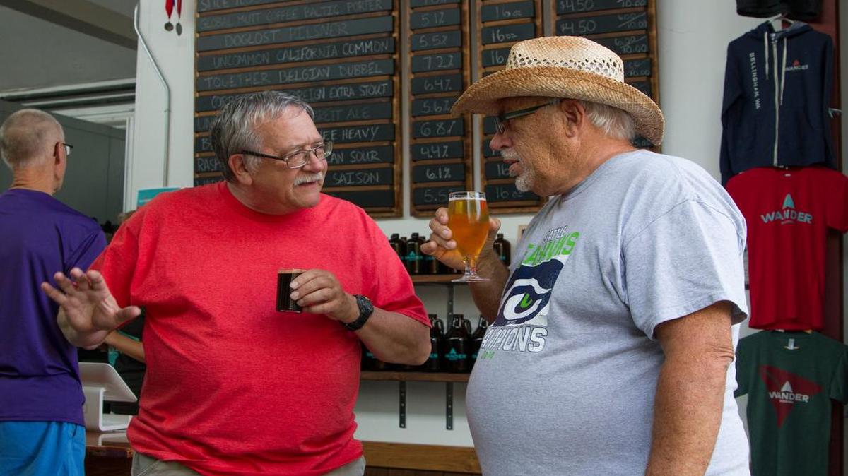 
Jim Garnett, left, and Bill Bergland, right, discuss the beers they got at Wander Brewing, 1807 Dean Ave., during a Bellingham Senior Activity Center outing July 7.

