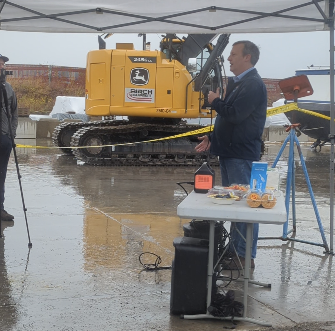 Newly-elected Commissioner of Public Lands Dave Upthegrove speaks to a crowd before the boat is deconstructed.