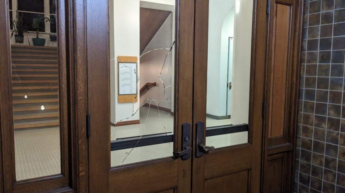 A shattered window in the front door to Western Washington University’s Old Main administration building is shown in a University Police photo on Oct. 22.