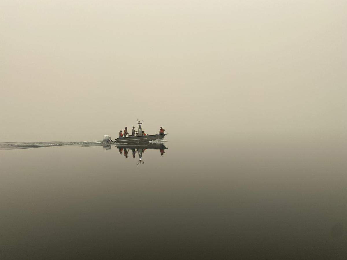 Firefighters boatd across Ross Lake while working on controlling the Perry Fire.