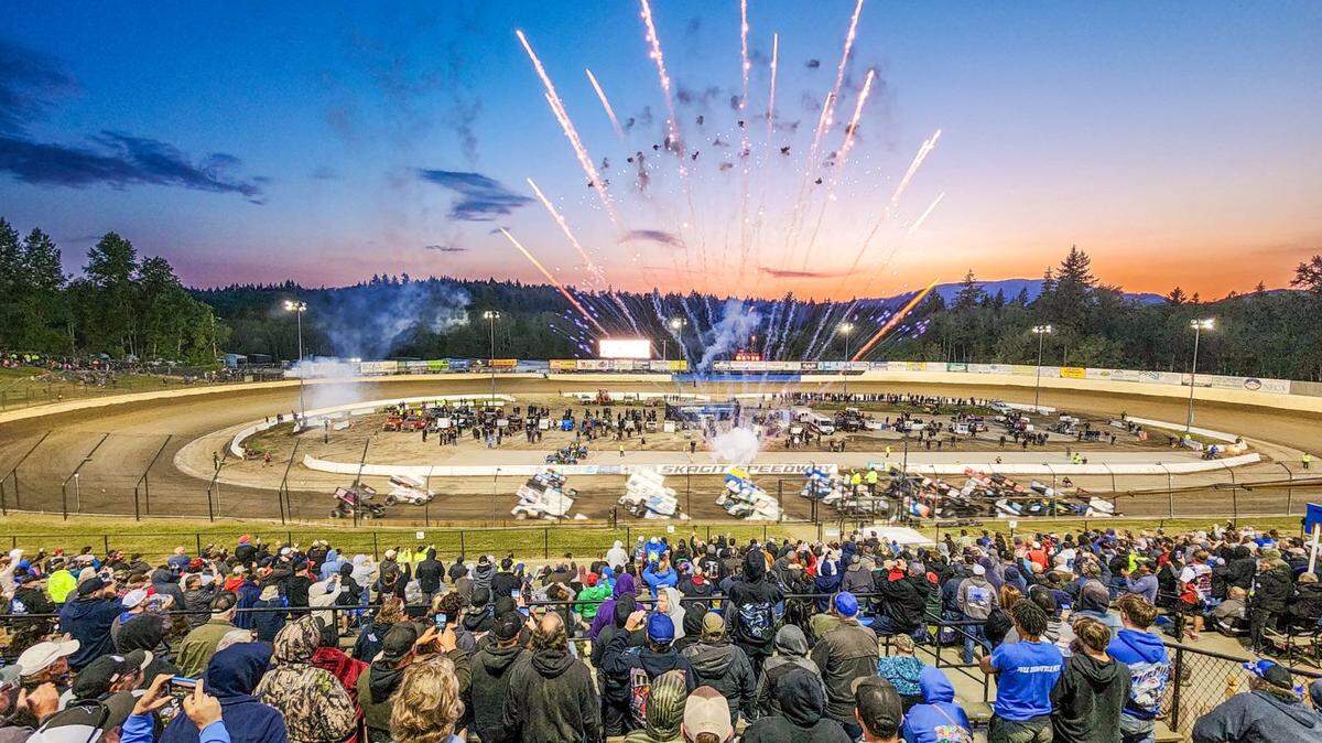 A fireworks display over the field of drivers at Skagit Speedway.