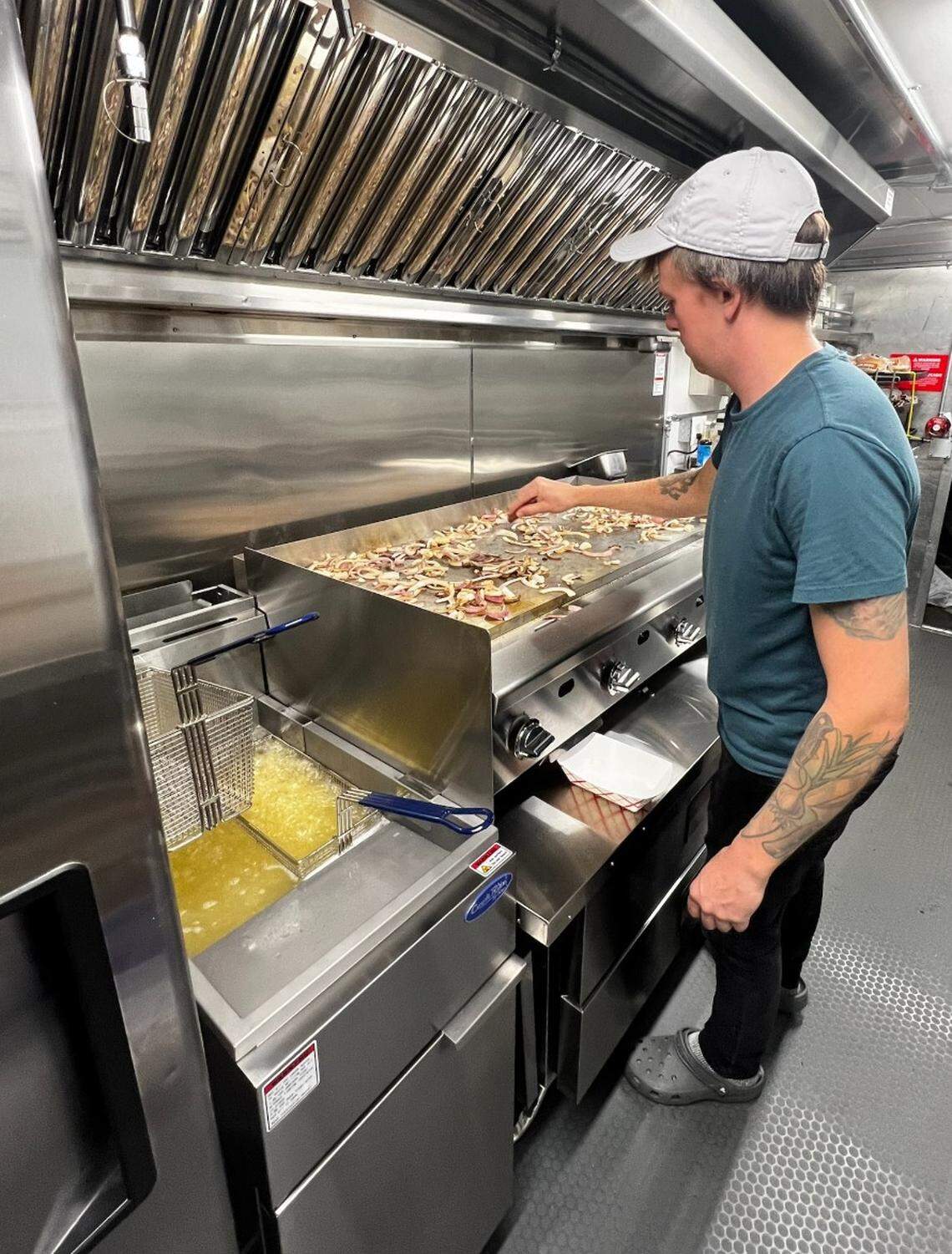 Matt King, the owner of Bellingham’s newest food truck, Doug’s Burgers cooking in his truck at 1301 N State St. in Bellingham, Wash.