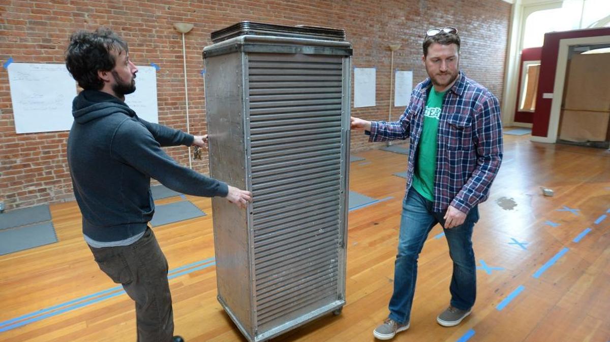 Goat Mountain Pizza owners Charlie Pasquier, left, and Chaz Kubis roll equipment into their new space on Holly Street Wednesday, Feb. 17, 2016. When the move into the former Film is Truth space on Holly is finished, the restaurant will have four times the space of its current location.