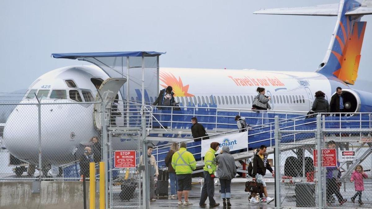 Passengers disembark from an Allegiant Air flight that had just taken off from Bellingham International Airport and had to turn around and make an emergency landing Jan. 4, 2012, due to smoke in the plane’s cabin.