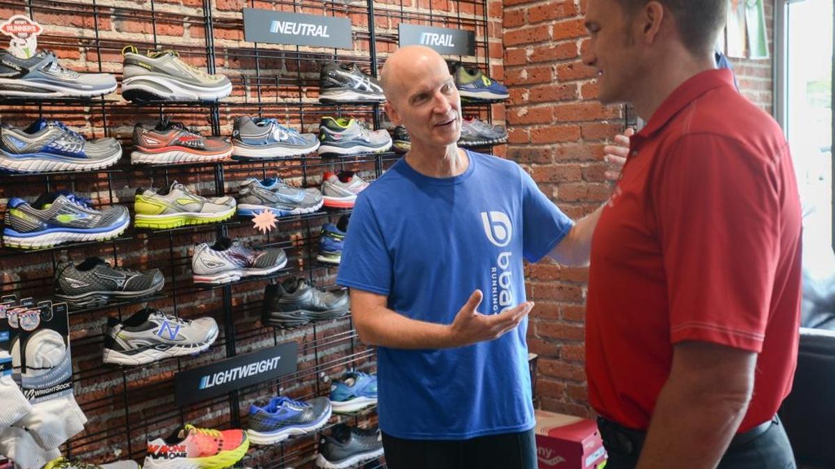 BBay Running owner David Penrose, left, talks with sports chiropractor Eric DeRoche about shoes at the State Street store in Bellingham on Thursday, June 30, 2016. Penrose bought the Klicks running store and changed the name.