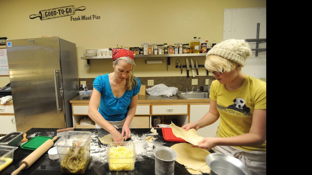 
Holly Bevan-Bumford, owner of Good To Go, makes meat pies in the kitchen of her location at 128 Main St., Everson, while staff member Brianna Day stacks pastry dough on Feb. 29, 2012. Good to Go Meat Pies was one of 39 local restaurants to receive a 2014 Silver Platter Award for food safety from the Whatcom County Health Department.
