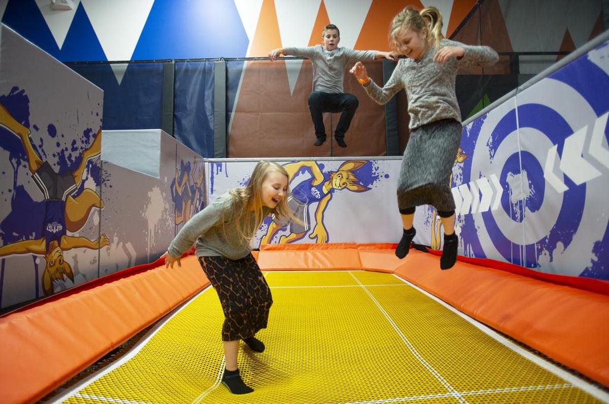 Hailey Castleman, 11, Derek Castleman, 14, and Jocelyn Hall, 10, jump on a trampoline at Summit Trampoline Park in Bellingham. The group was at the park for Hall’s birthday.