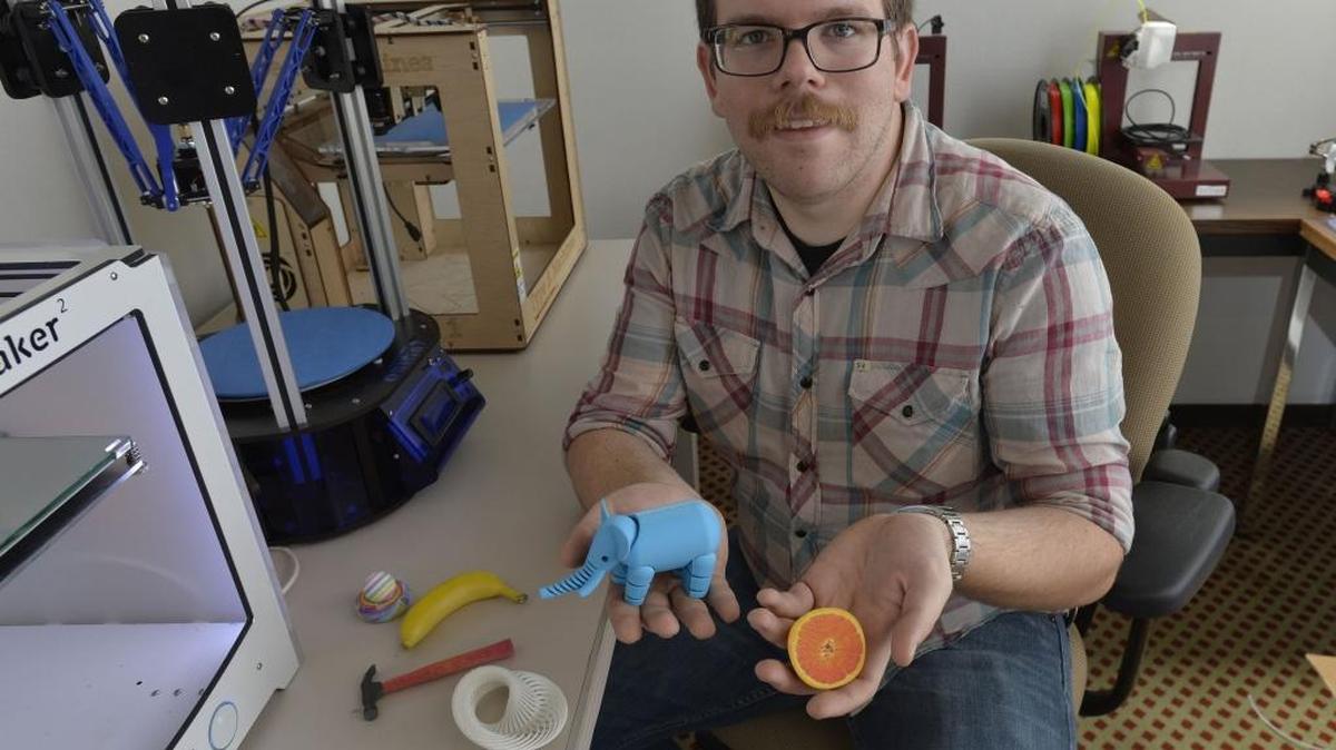 Troy Greig shows some of the things made from 3-D printers at The Foundry, 1515 North State Street, in 2015.